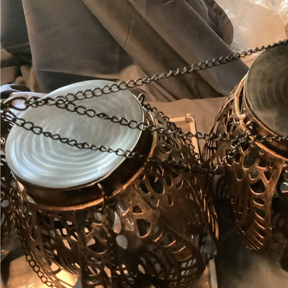 3 ornate tree lanterns outside